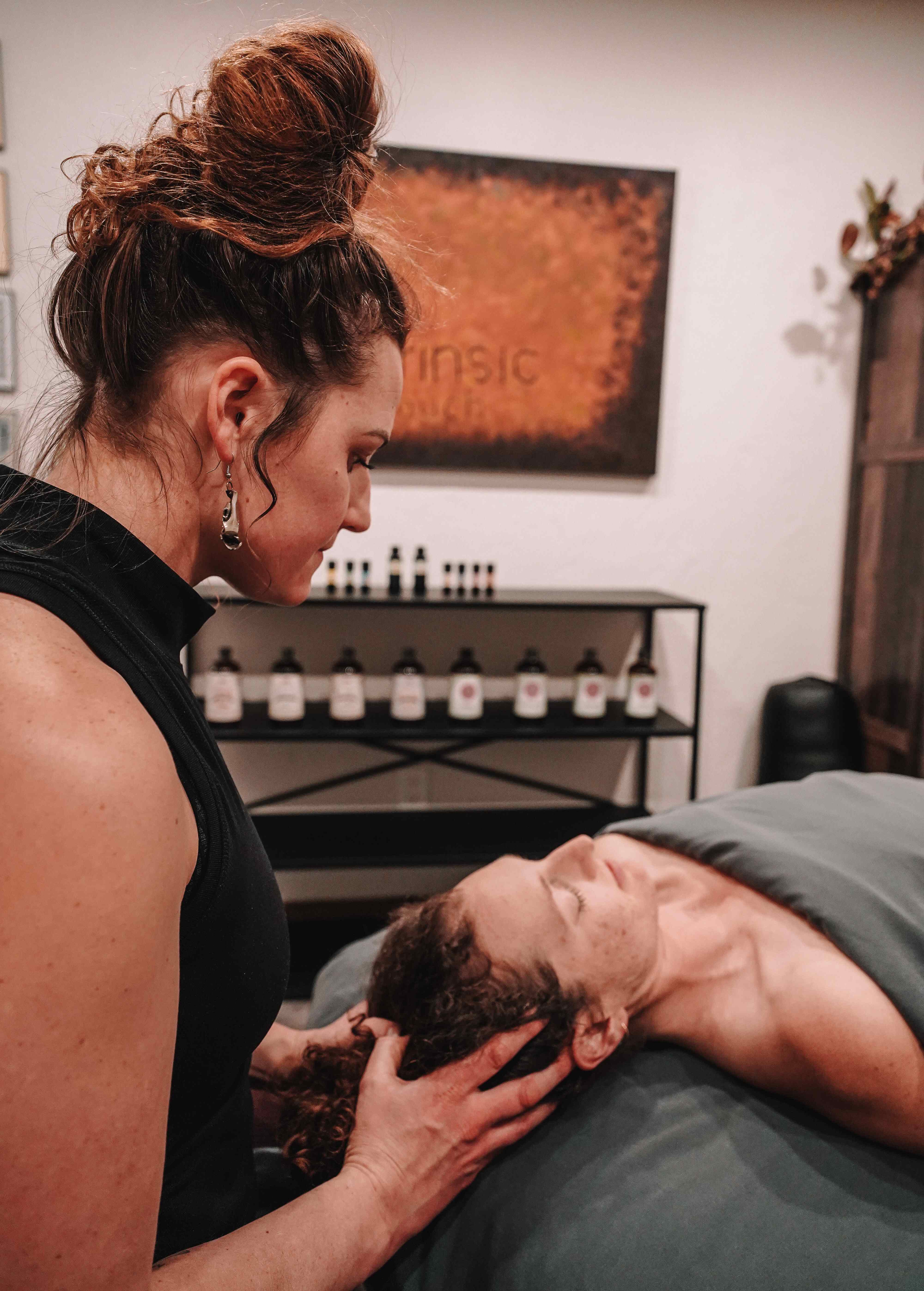 Tristin performing face zonology on a relaxed client