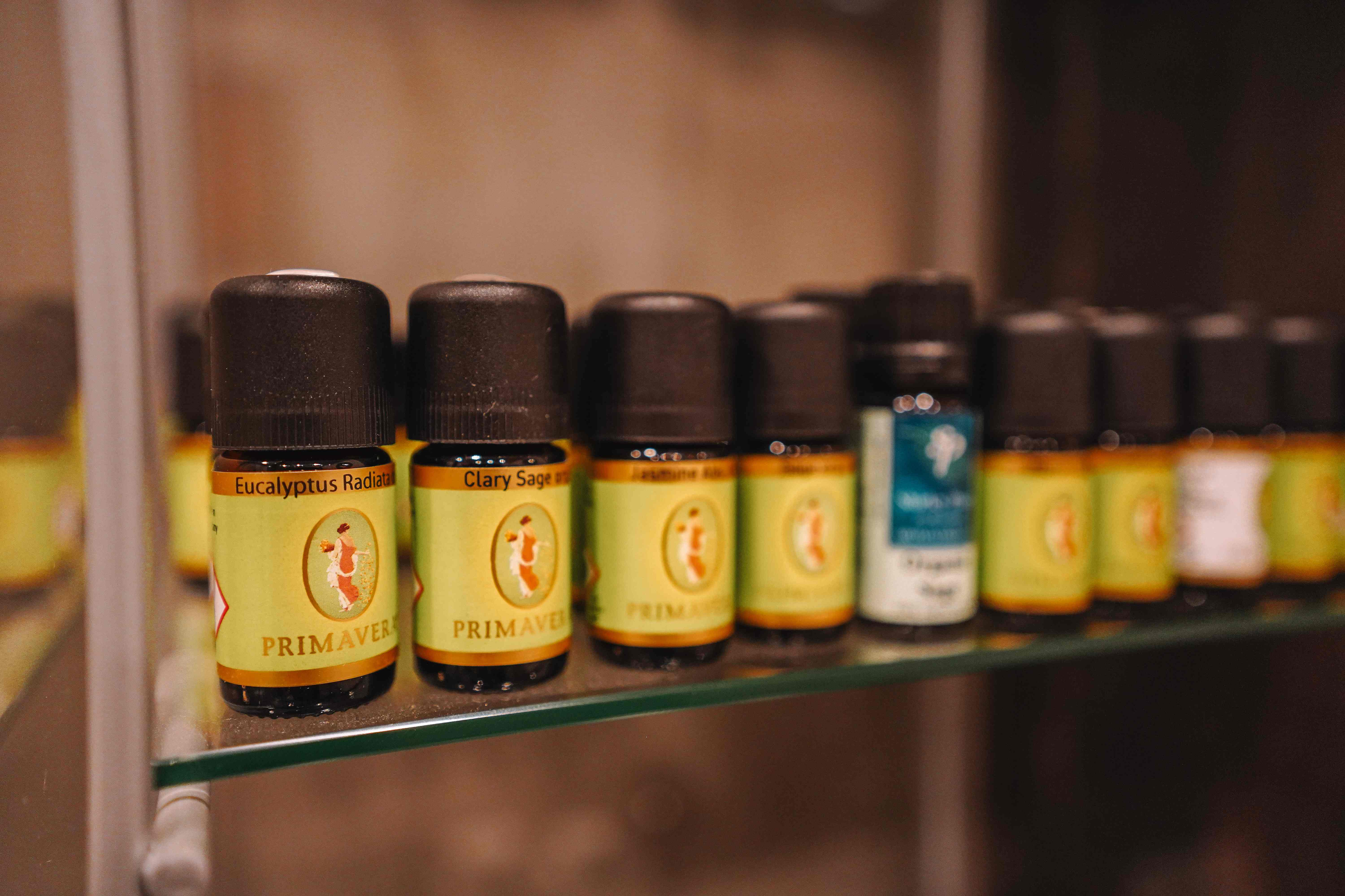 Primavera organic essential oils lined up on a glass shelf
